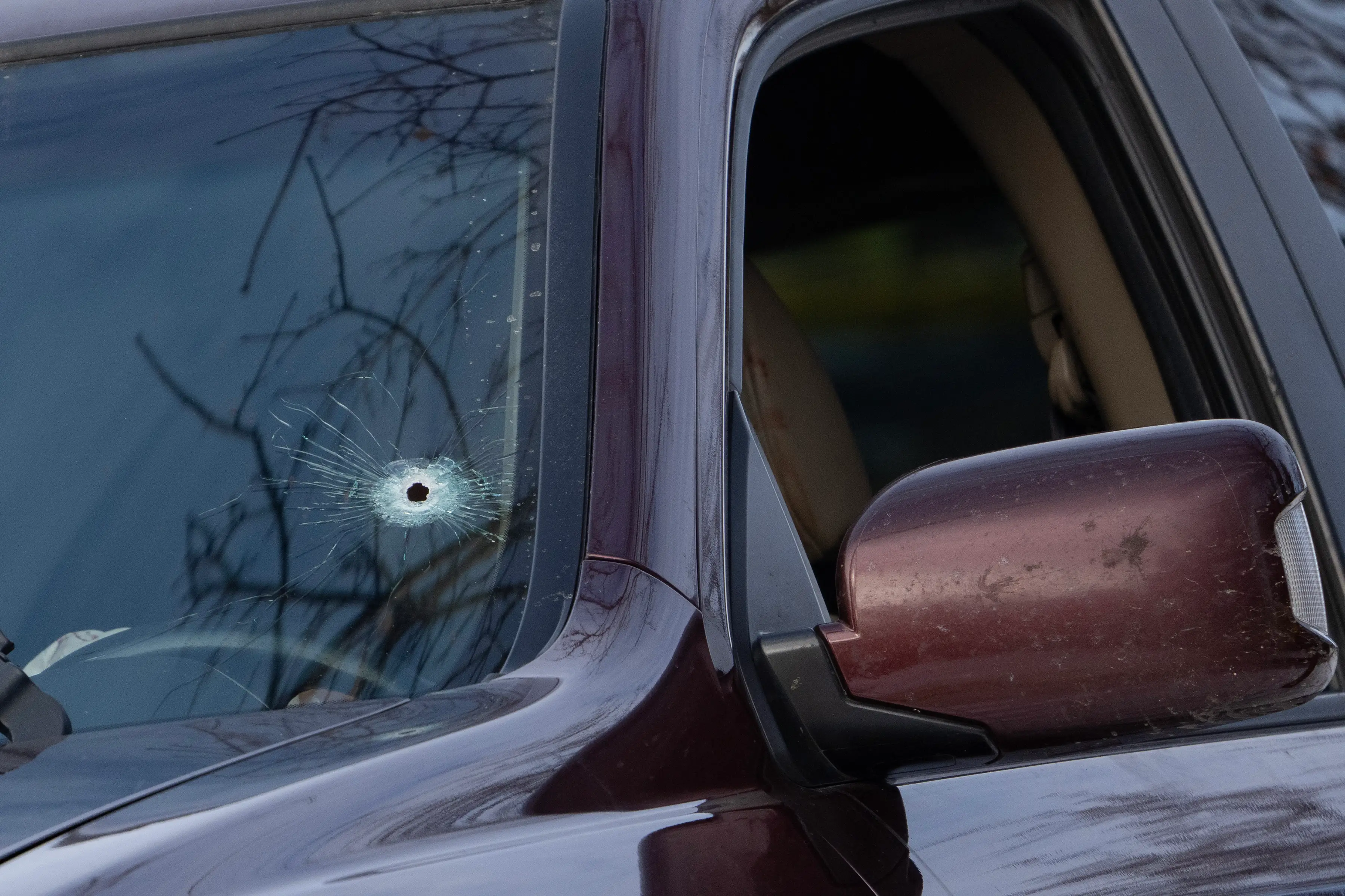 The couple's car was shot through the windshield ( Alex Kormann/The Minnesota Star Tribune via Getty Images)