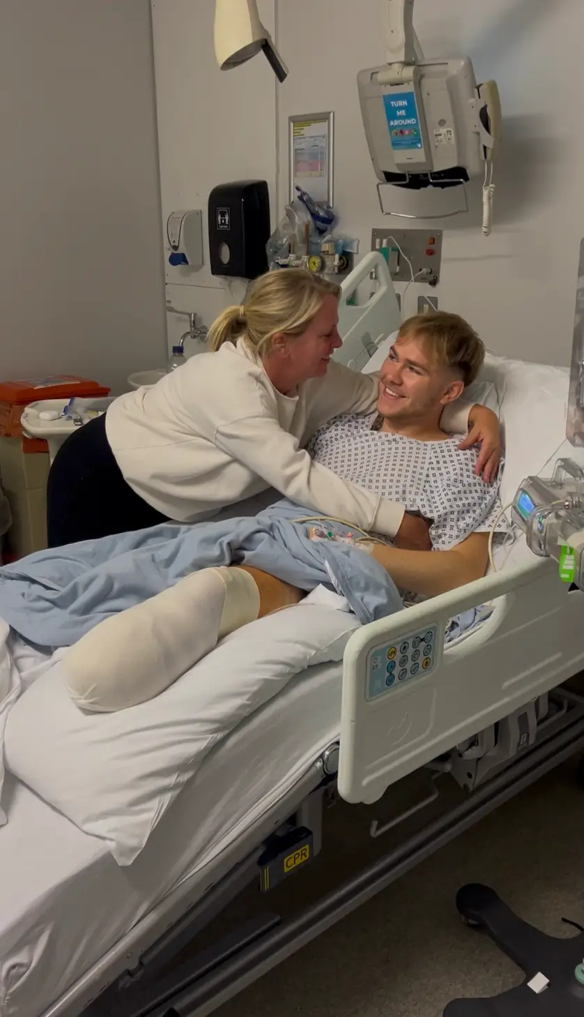 Tommy Hurrell, pictured receiving a hug from his mom, made the heartbreaking decision to amputate his leg following a half-a-lifetime of complications with his left foot (Tommy Hurrell)