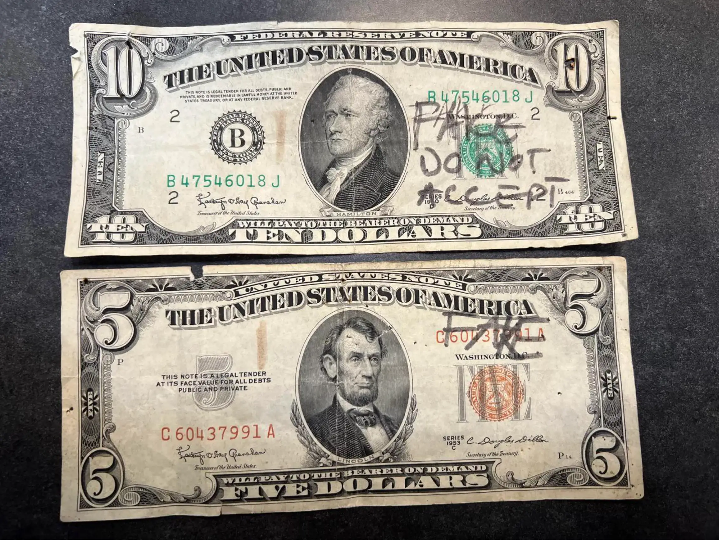 Sam shared a picture of a real $10 bill, dating back to 1950, and an authentic $5 bill from 1953 that both had the word 'fake' written on them (Reddit/PhillipEngMBTA)