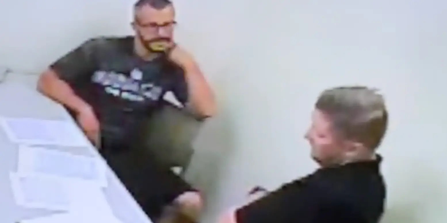 Chris Watts gesturing towards his neck.