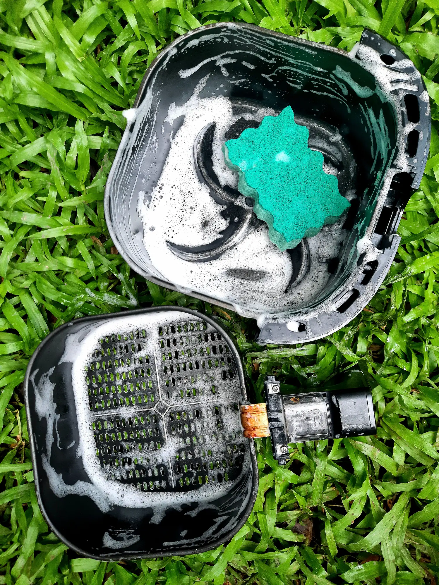 So make sure to give your air fryer a good clean... but maybe not outside on the grass (Getty stock)