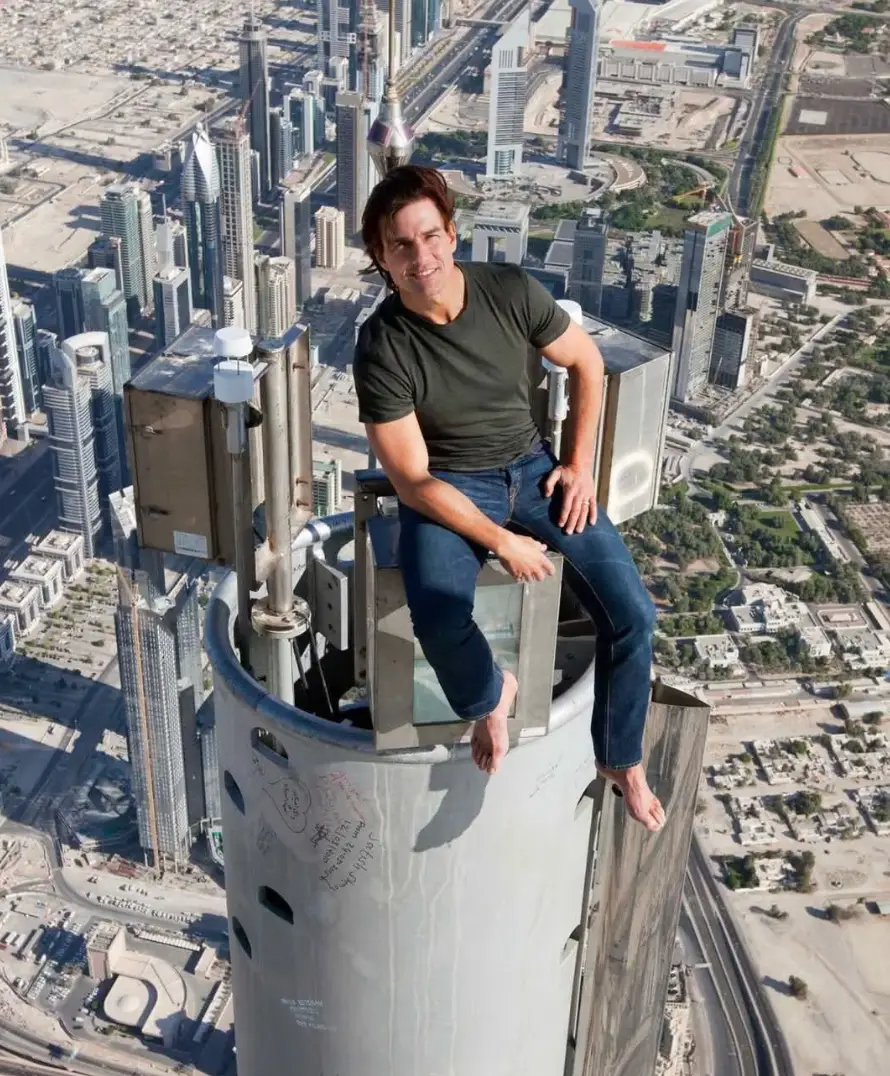 It's hard to believe Tom Cruise is sat upon the tallest building in the world (X/David James)