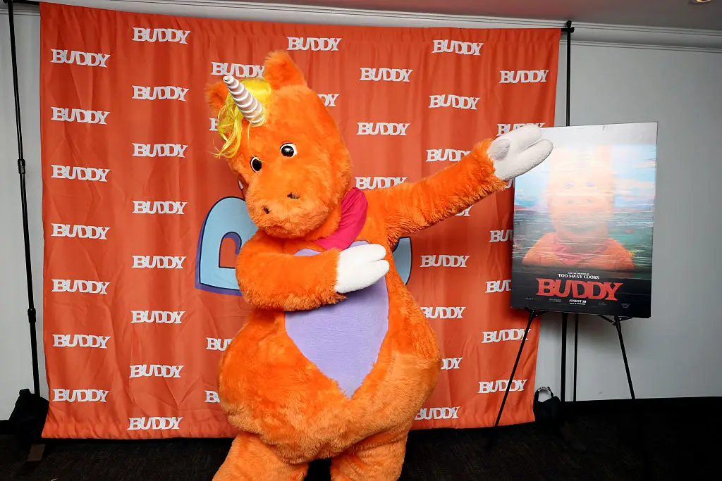 Buddy follows children trapped inside a 1990s television show hosted by a giant orange unicorn. (Photo by Eric Charbonneau/Roadside Attractions via Getty Images)