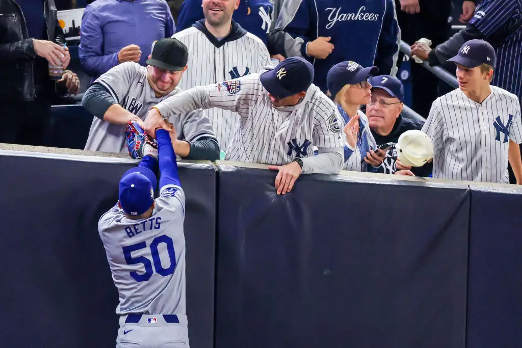 Two New York Yankees supporters were seen trying to snatch the ball from Mookie Betts (Al Bello/Getty Images)