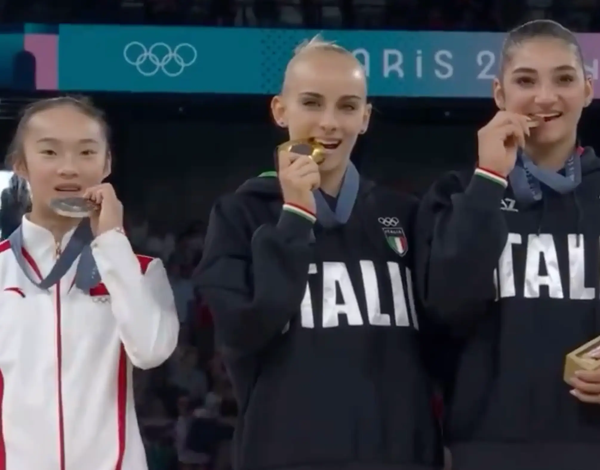 The gymnast quickly also brought her own medal up to her mouth. (BBC)