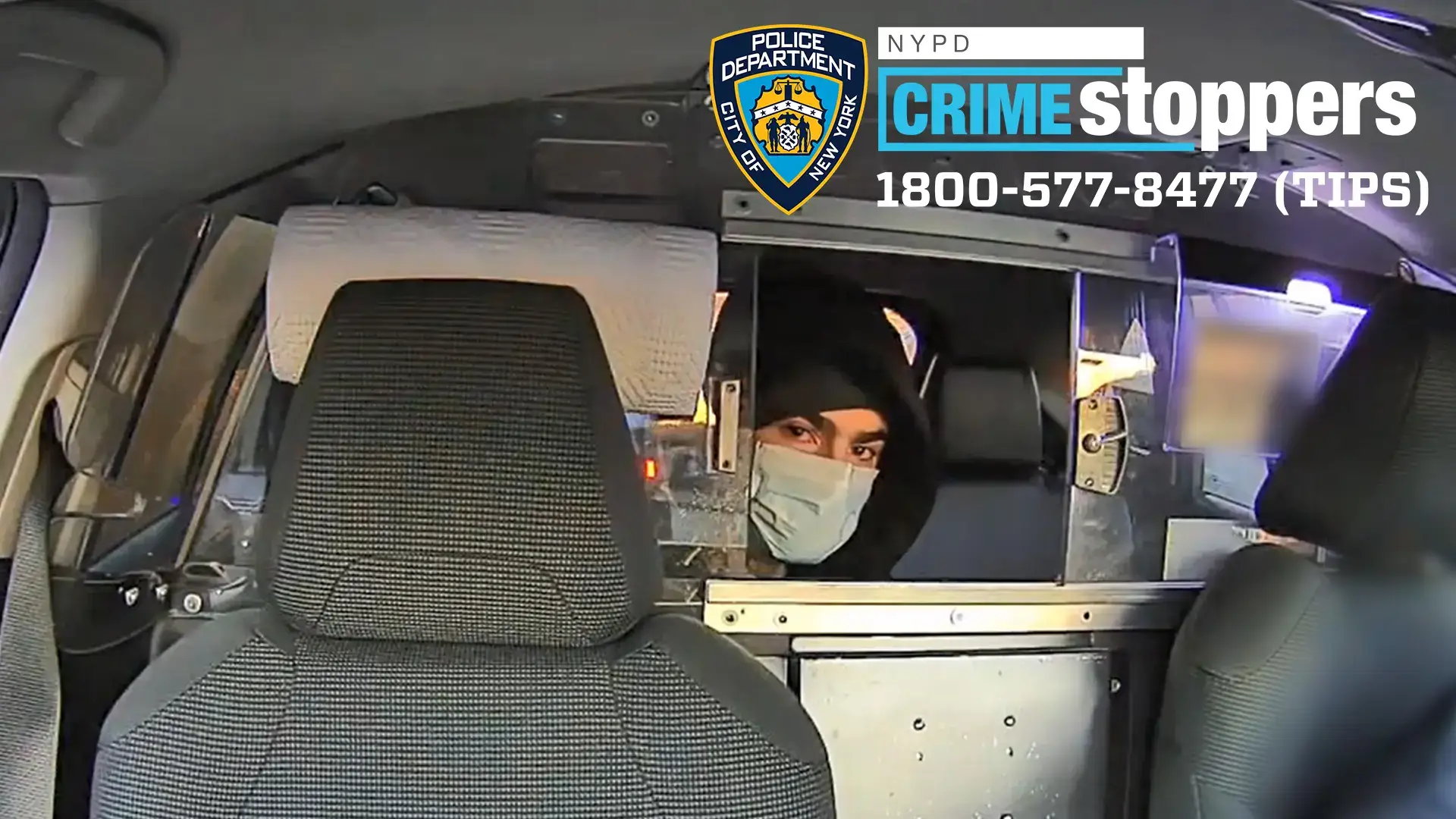 The suspect looks directly at a camera while speaking to a cab driver following the murder of Brian Thompson (DCPI)