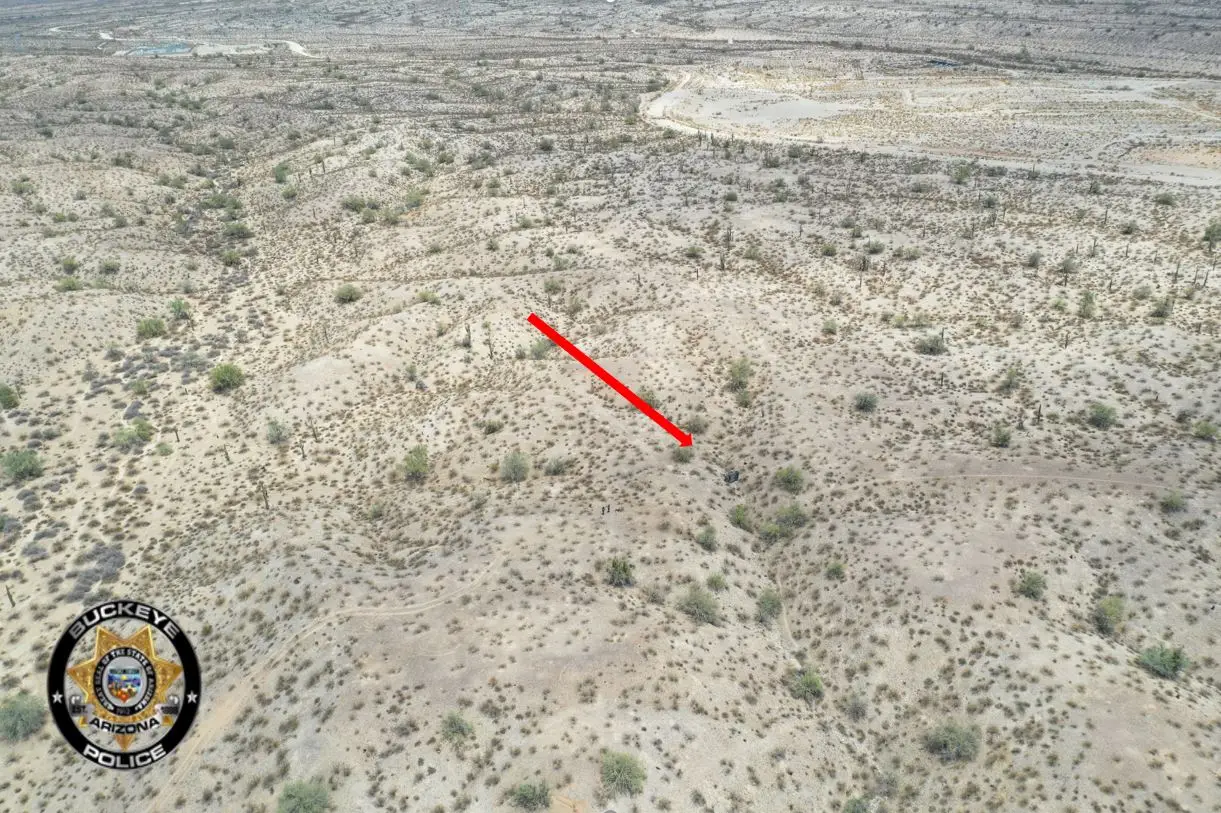 An arrow points to where the crash took place while the arial shot shows just how baron the landscape of the scene is. (Buckeye Police Department)