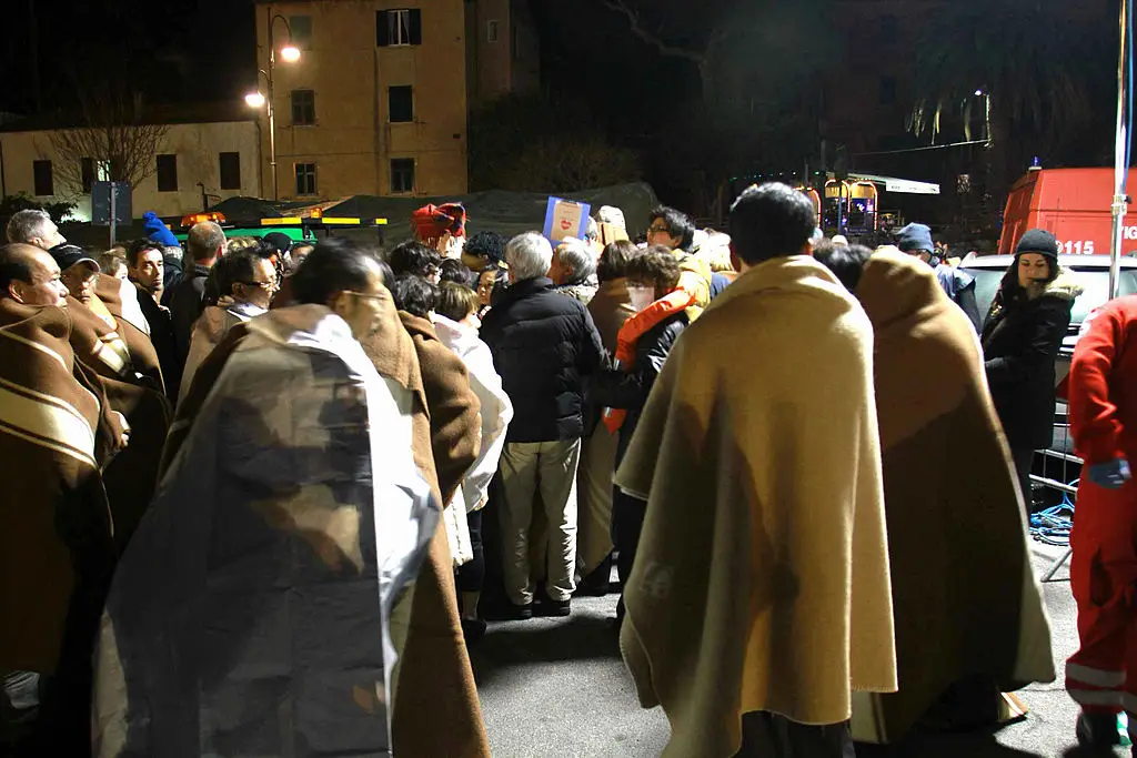  A photograph taken early on January 14, A photograph taken early on January 14, 2012 shows passengers of the Costa Concordia arriving at the Giglio island harbour, after the cruise ship with more than 4,000 people on board ran aground and keeled over off the Isola del Giglio (STRINGER/AFP via Getty Images)