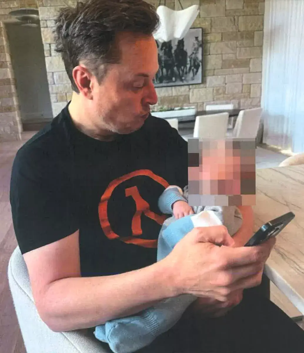 Musk pictured holding his alleged 13th child, Ashley St Clair's son, with the pair currently locked in a legal battle over the infant (Supreme Court of the state of New York, County of New York)