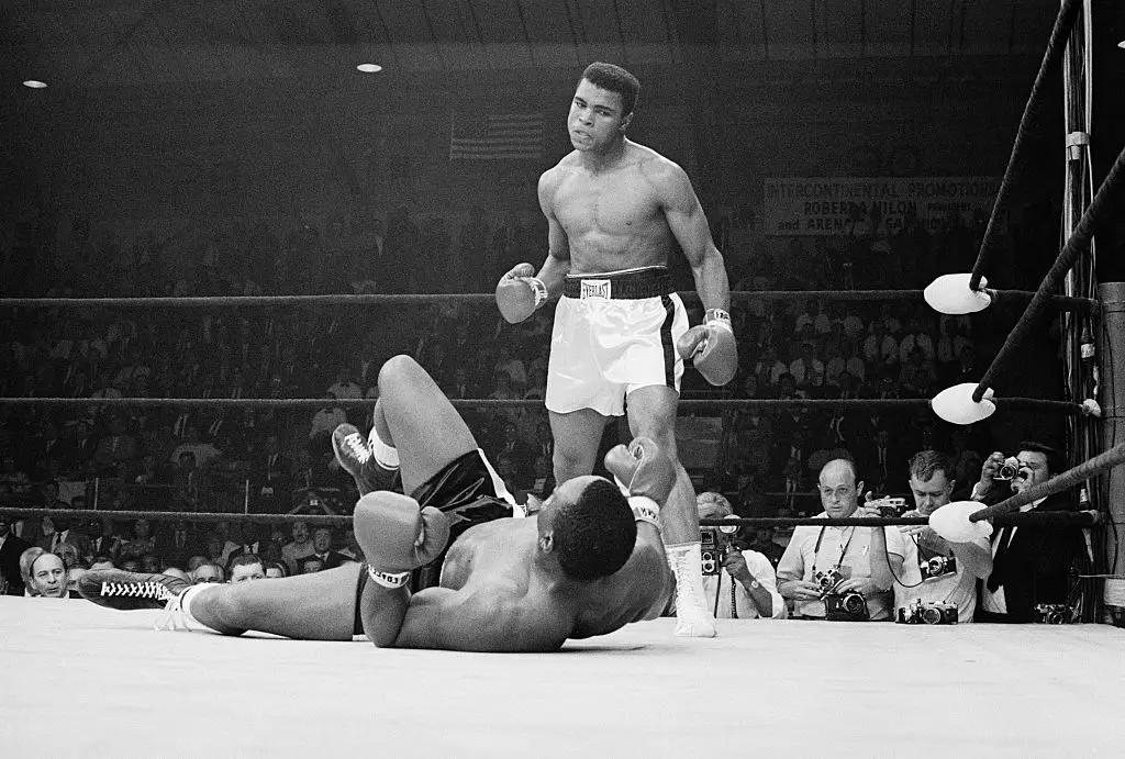 Muhammad Ali stands over Sonny Liston after knocking him down during the first round of their match, which Ali went on to win back in 1965 (Getty/Bettmann)