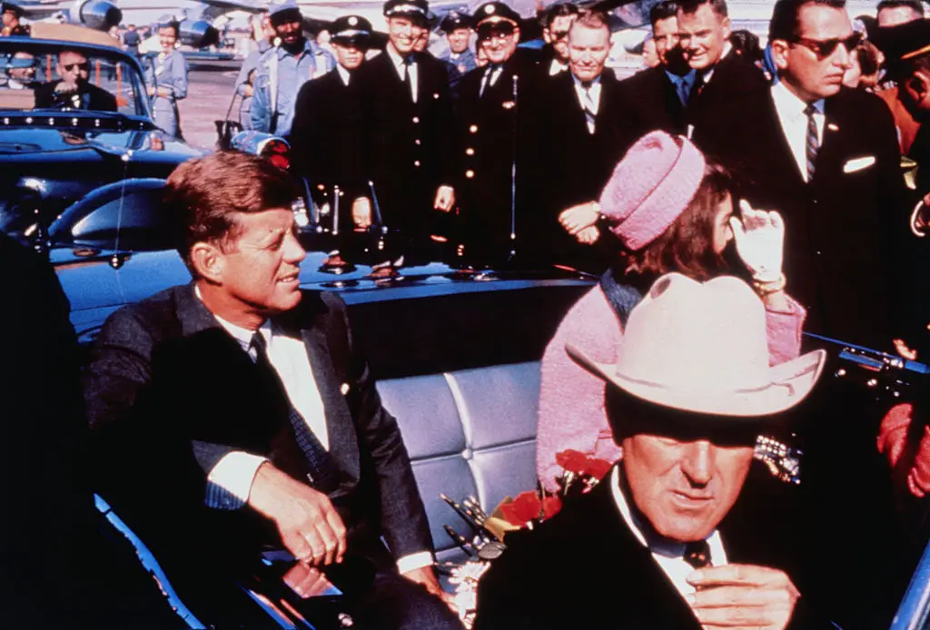  Texas Governor John Connally adjusts his tie as US President John F Kennedy (left) & First Lady Jacqueline Kennedy  settled in rear seats, prepared for motorcade into Dallas from airport on the day he was assassinated (Bettmann/Getty)