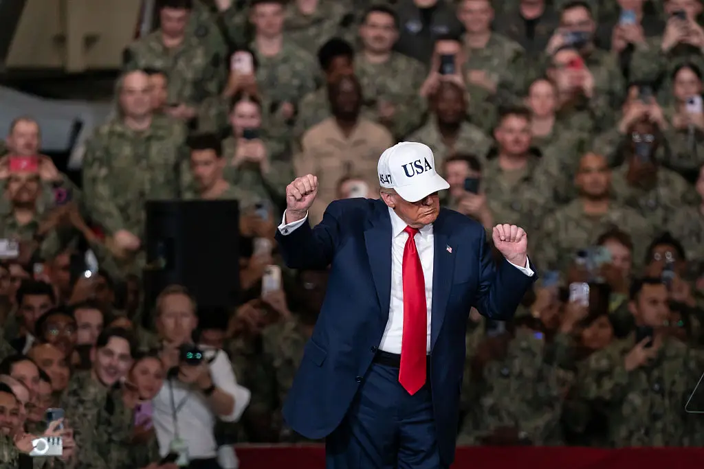 President Donald Trump dances as he speaks to troops aboard USS George Washington, on Tuesday, in Yokosuka, Japan (Tomohiro Ohsumi/Getty Images)