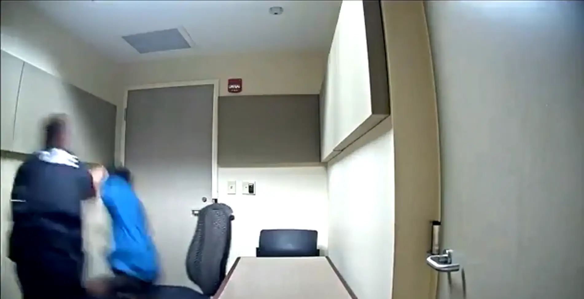 The man was pushed to the ground by the officer.