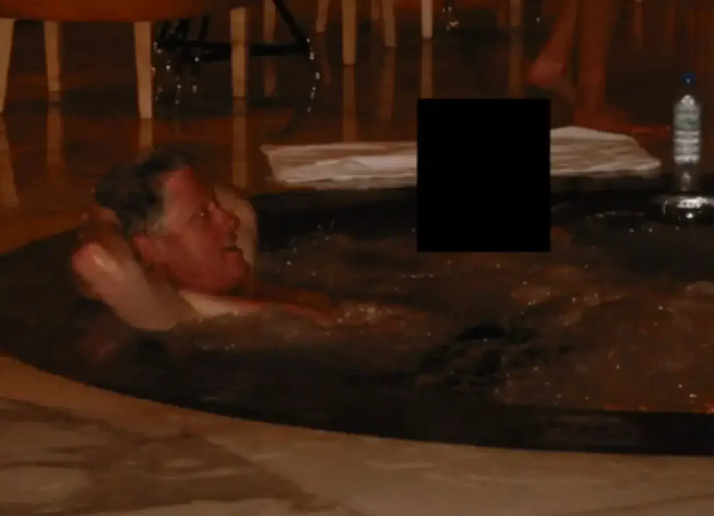 Another photo sees Clinton in what appears to be a hot tub (Department of Justice)