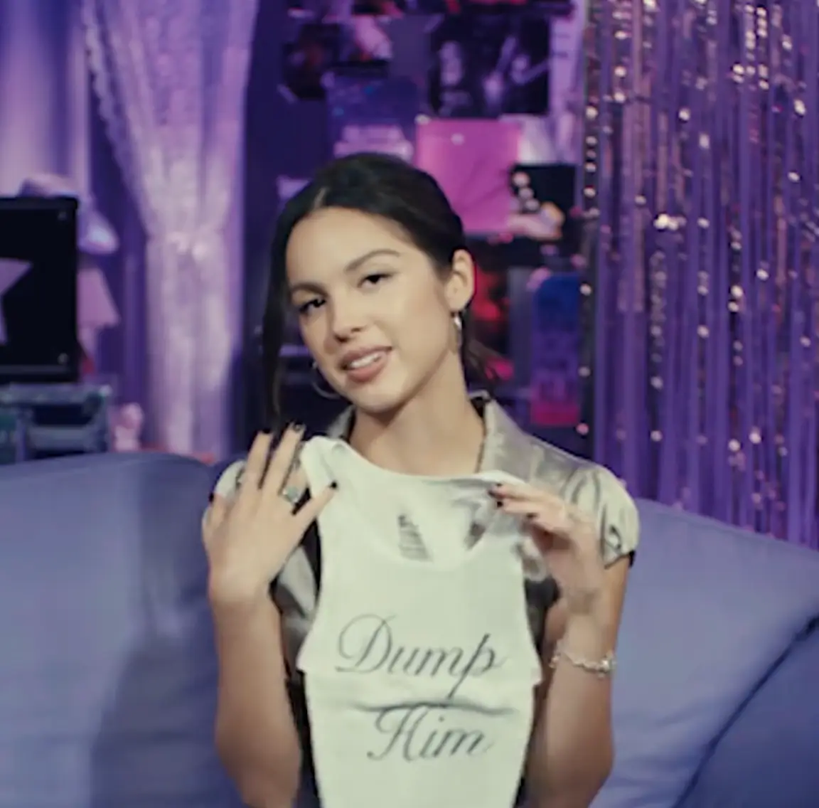 Olivia Rodrigo revealed what question she asks on first dates after talking about a tank top she wore on her GUTS World Tour which read 'Dump Him' (TikTok/Netflix)