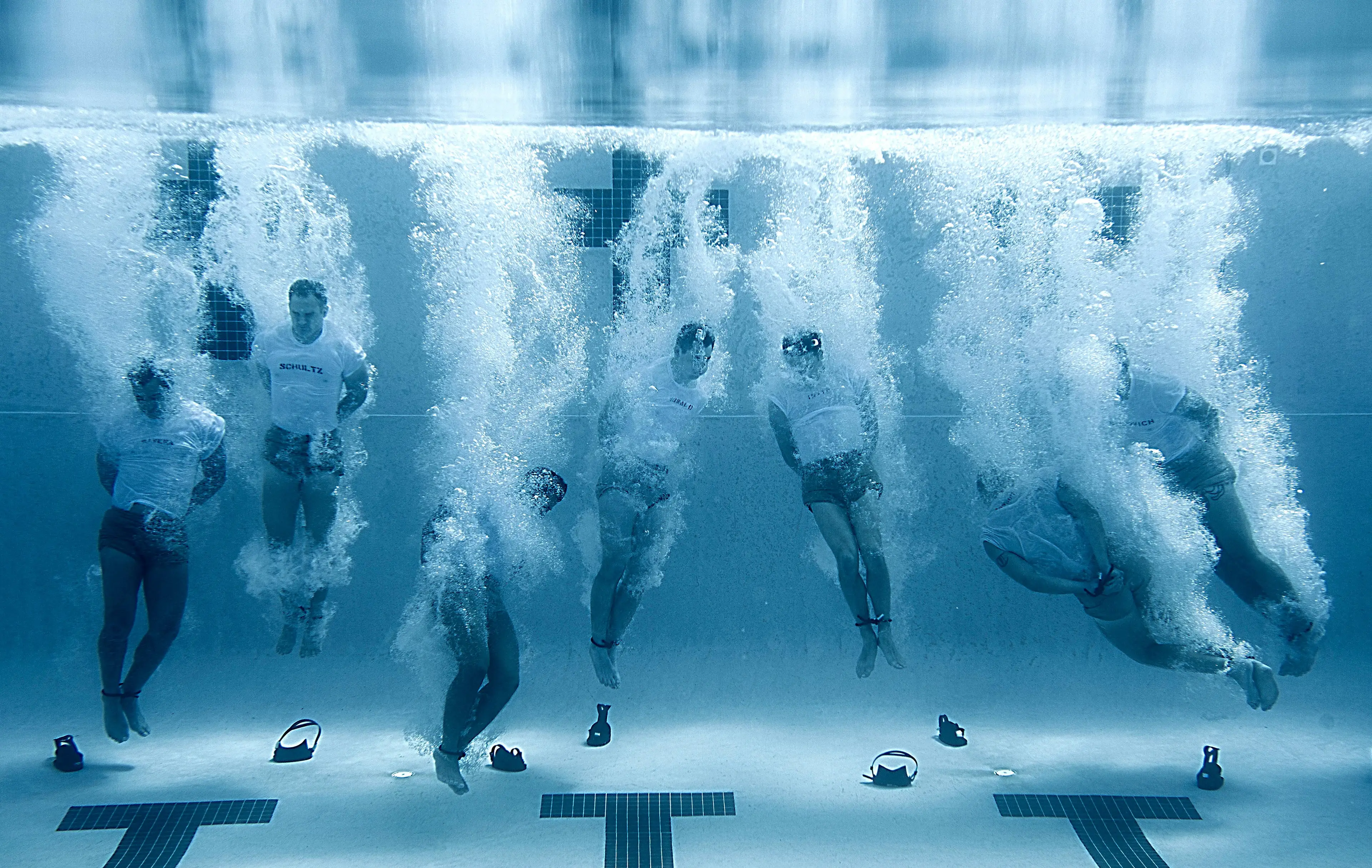 U.S Navy SEALs sink to the bottom of a pool with their hands and feet bound during drown proofing exercises at the Naval Special Warfare Center June 23, 2012.