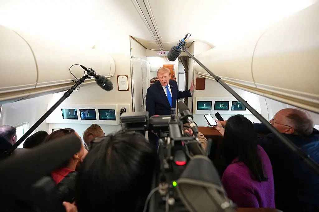 When asked about why the blinds were shut, Trump said to journalists: 'because you're probably on a dangerous flight because of the sleaze bags that we have to deal with.' (Photo by Aaron Schwartz / AFP via Getty Images)