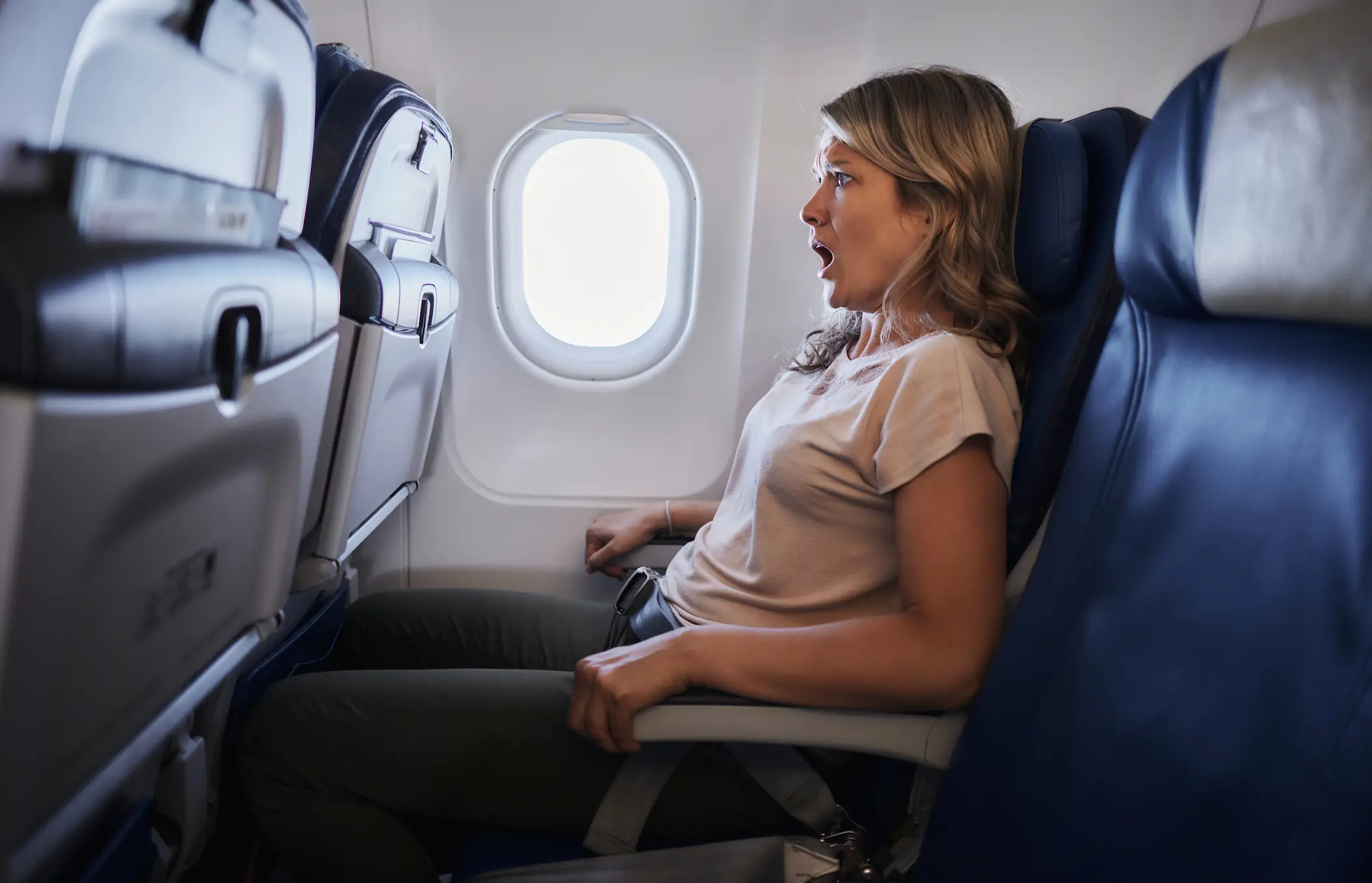 The face you make when you realize someone is touching your hair on a flight (Getty Stock Image)