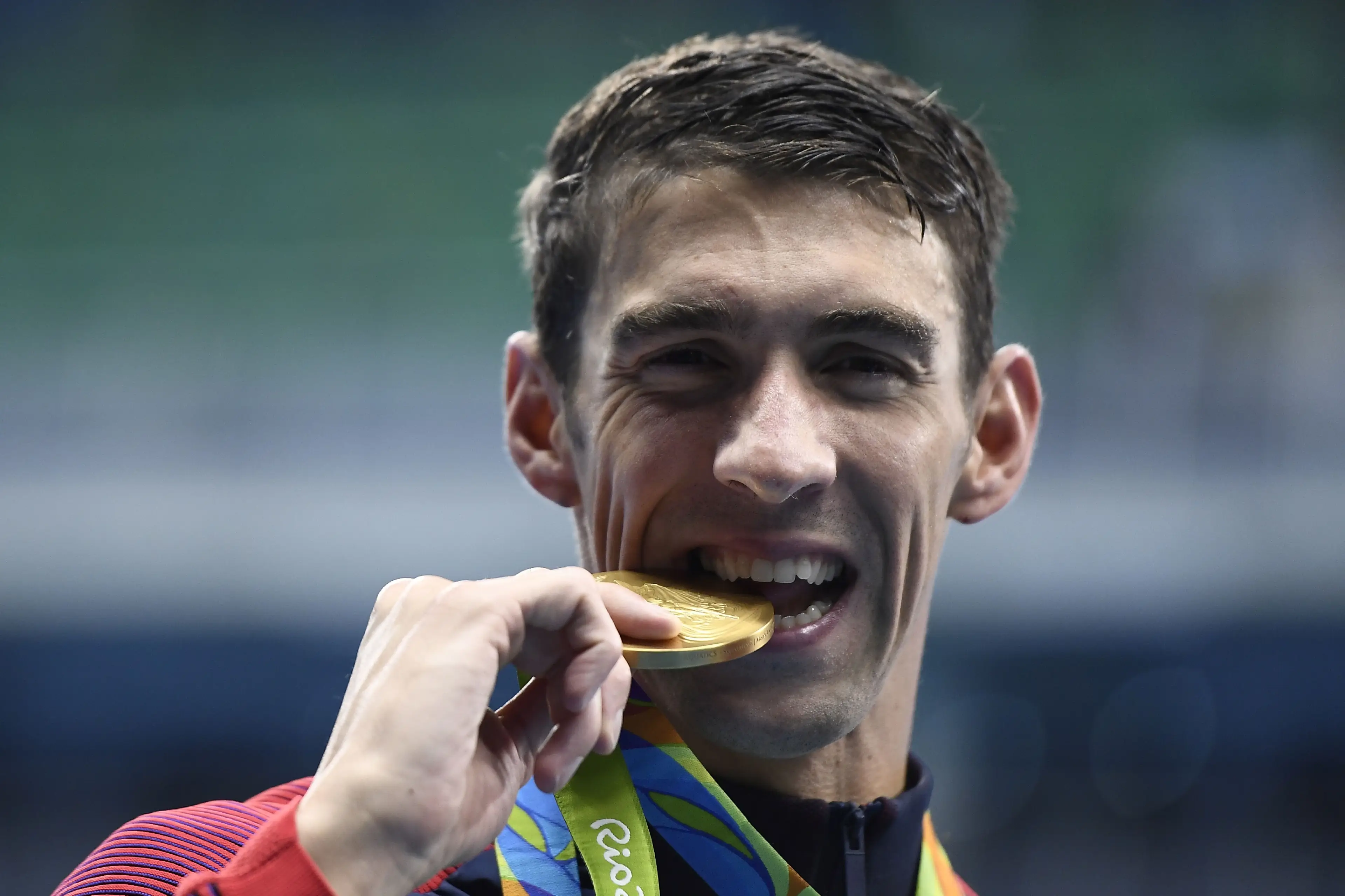 Michael Phelps also biting his own medal 2016.(GABRIEL BOUYS/AFP via Getty Images)