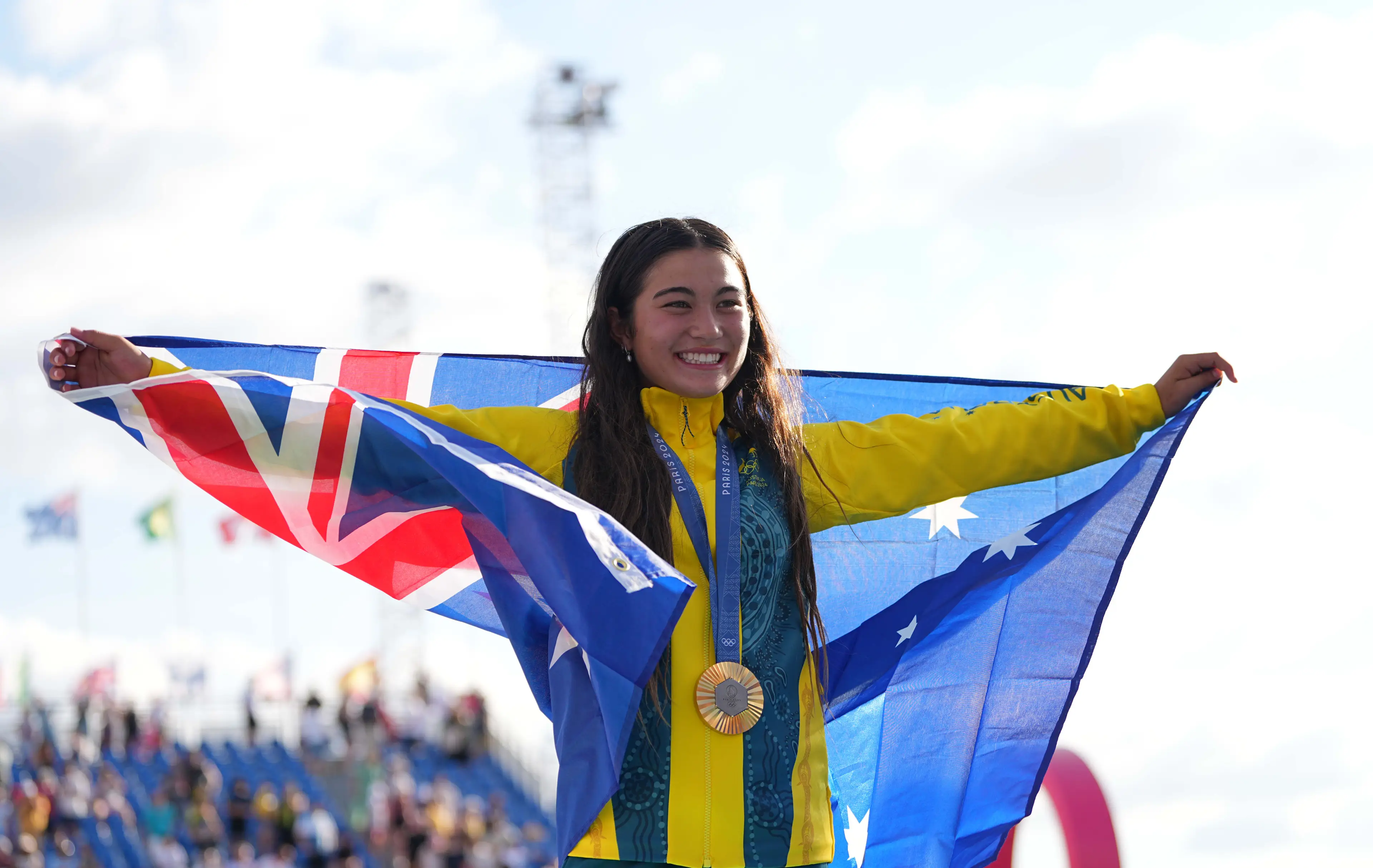 Arisa Trew showing off her medal while holding the Australian flag.(Ulrik Pedersen/DeFodi Images via Getty Images)