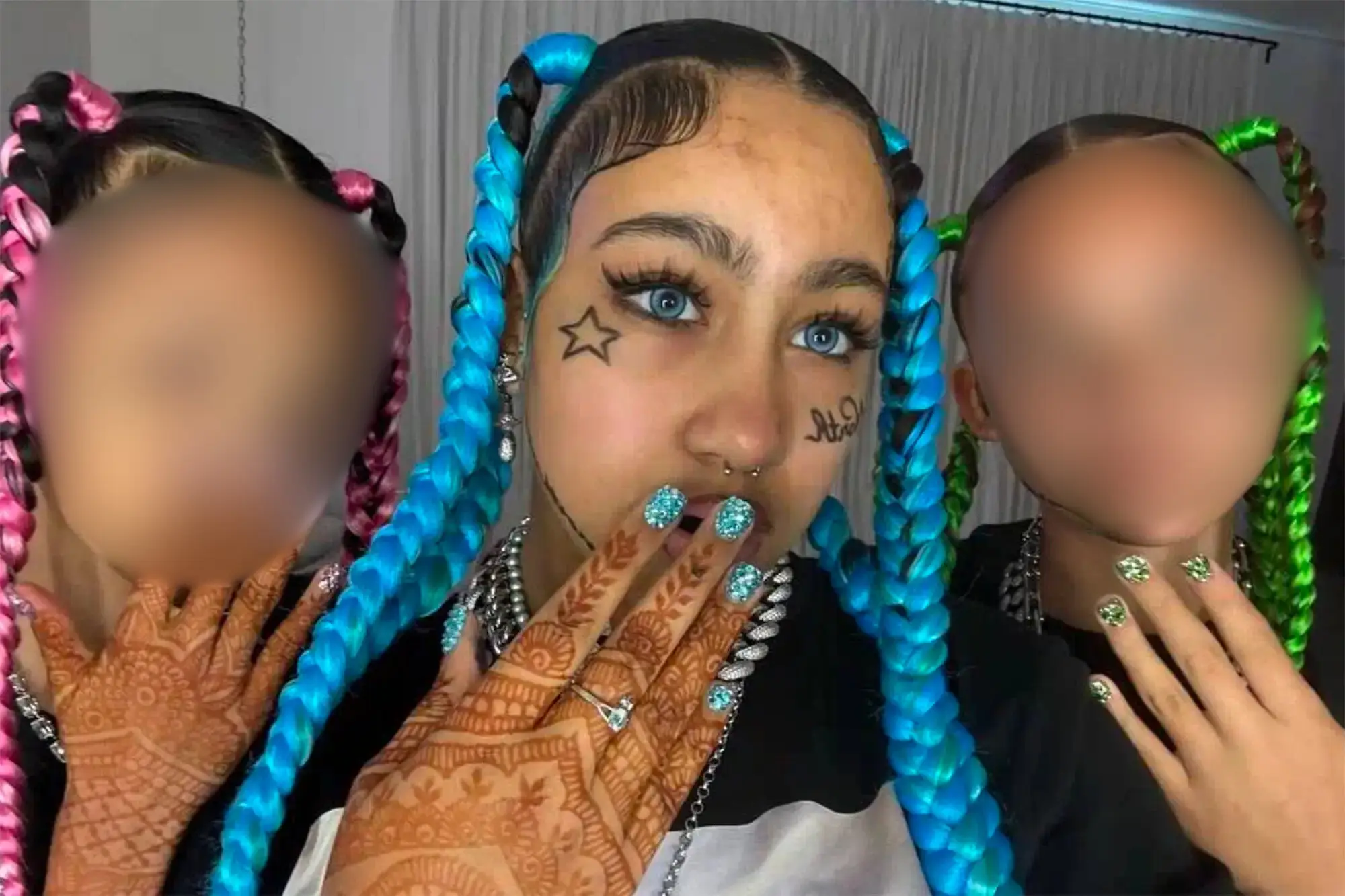 North West caused a stir online after posting a series of TikToks depicting her and her friends with fake facial tattoos and grillz (TikTok/Kim and North)