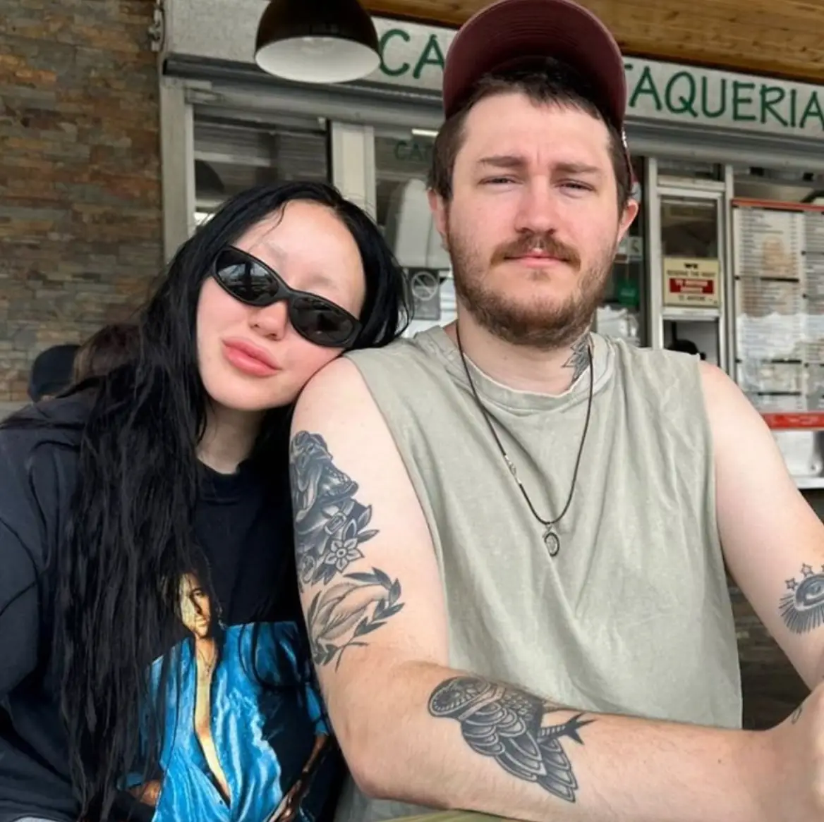 Noah was pictured wearing a jumper with a picture of her dad on it.