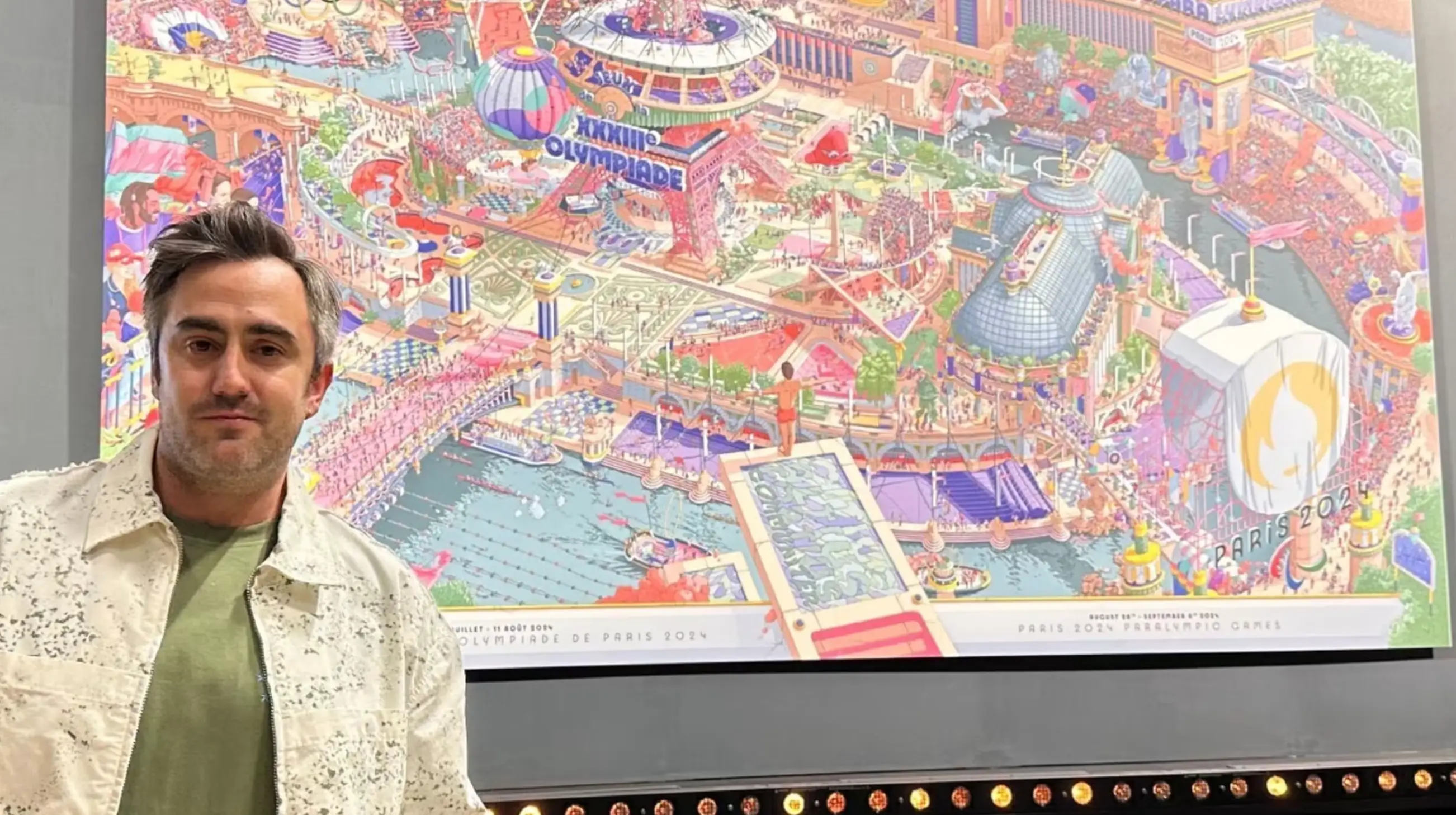 Artist of the official poster for the Paris 2024 Olympics Ugo Gattoni, with his design. (Olympics.com)
