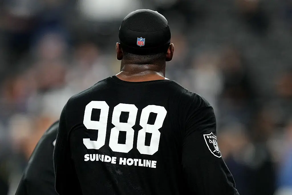 Raiders players wore warmup shirts displaying the suicide hotline number (Photo by Candice Ward/Getty Images)