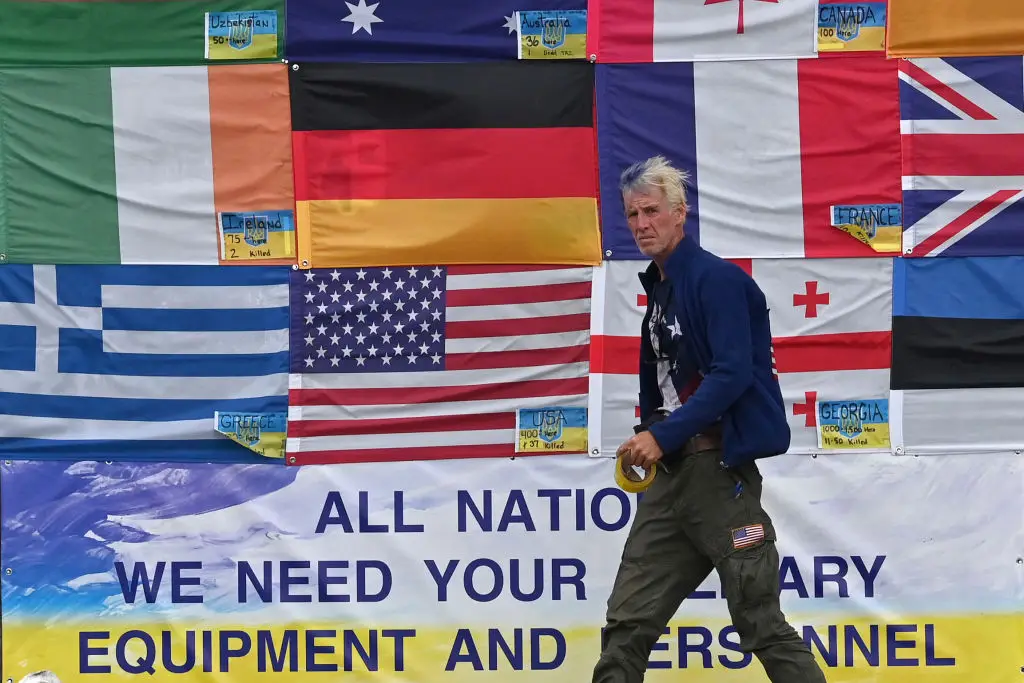 This photograph taken on Independence Square in Kyiv on June 23, 2022 shows US citizen Ryan Wesley Routh sticking up national flags of the countries helping Ukraine (SERGEI SUPINSKY/AFP via Getty Images)