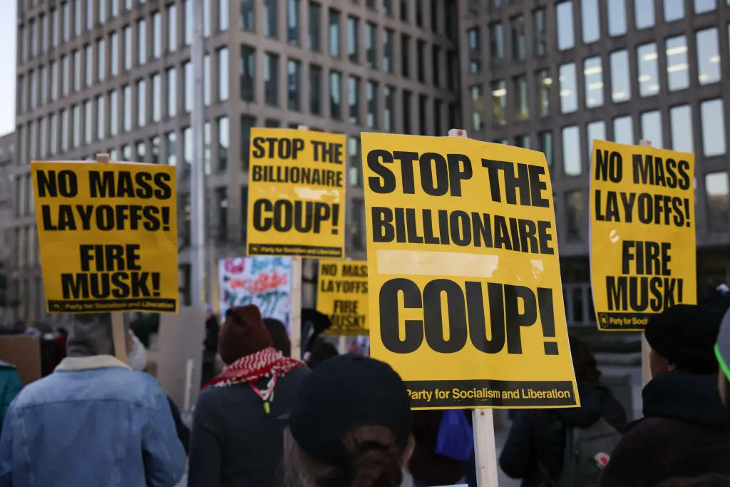 Demonstrators gather outside of the Office of Personnel Management in Washington, DC on February 7, to protest federal layoffs and demand the termination of Elon Musk from the Department of Government Efficiency (BRYAN DOZIER/Middle East Images/AFP via Getty Images)