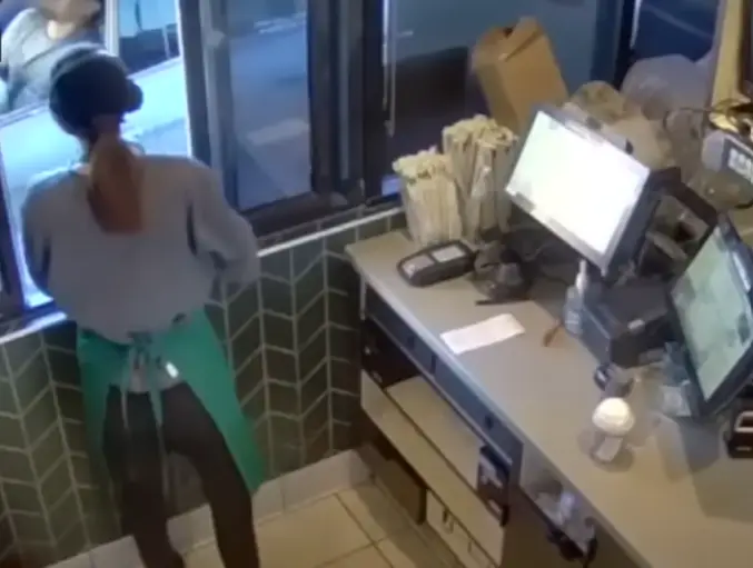 The security footage shows Garcia writhing in pain as the tea spills on him (KCAL News)