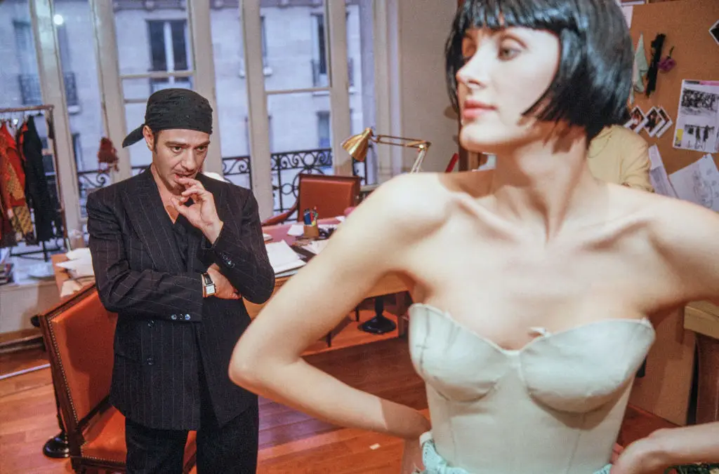 British fashion designer Galliano pictured back in 2005 working with a fashion model and assistants during a fitting session fat Christian Dior's headquarters (Derek Hudson/Getty Images)