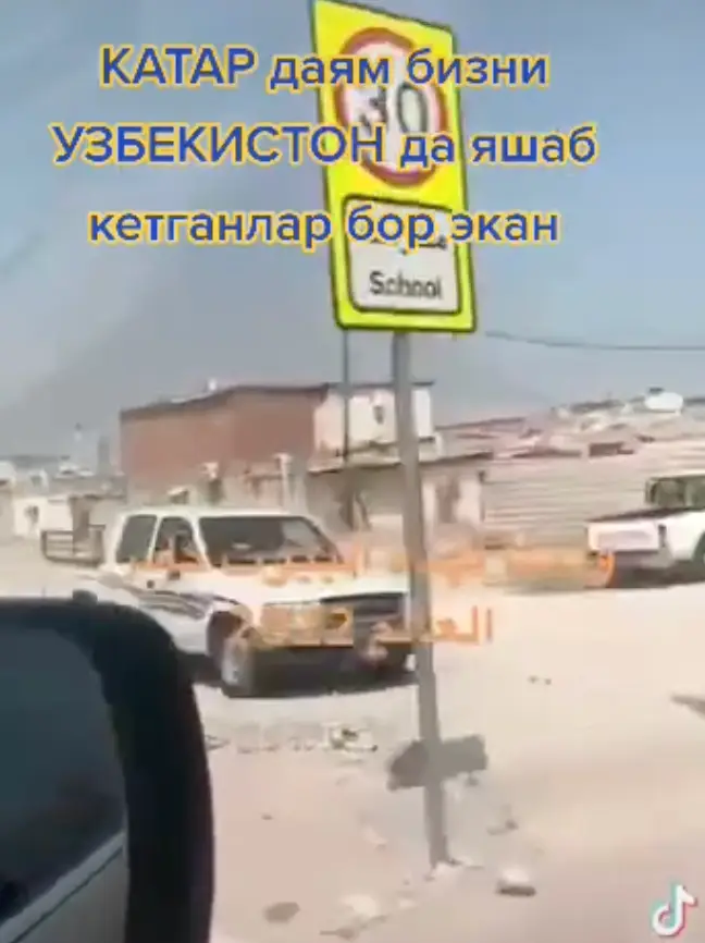 The gap in the wall reveals a less affluent area behind.