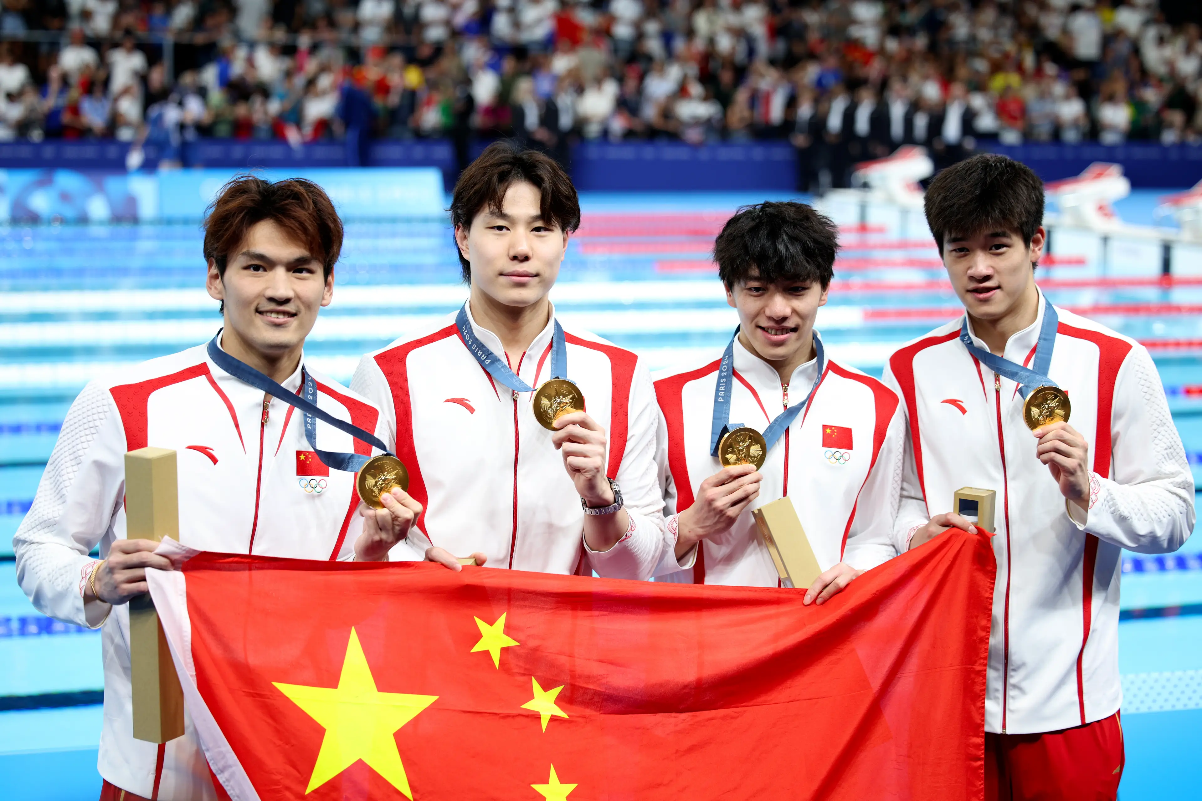 Qin Haiyang posing with his teammates after winning gold in Paris. (Adam Pretty/Getty Images)