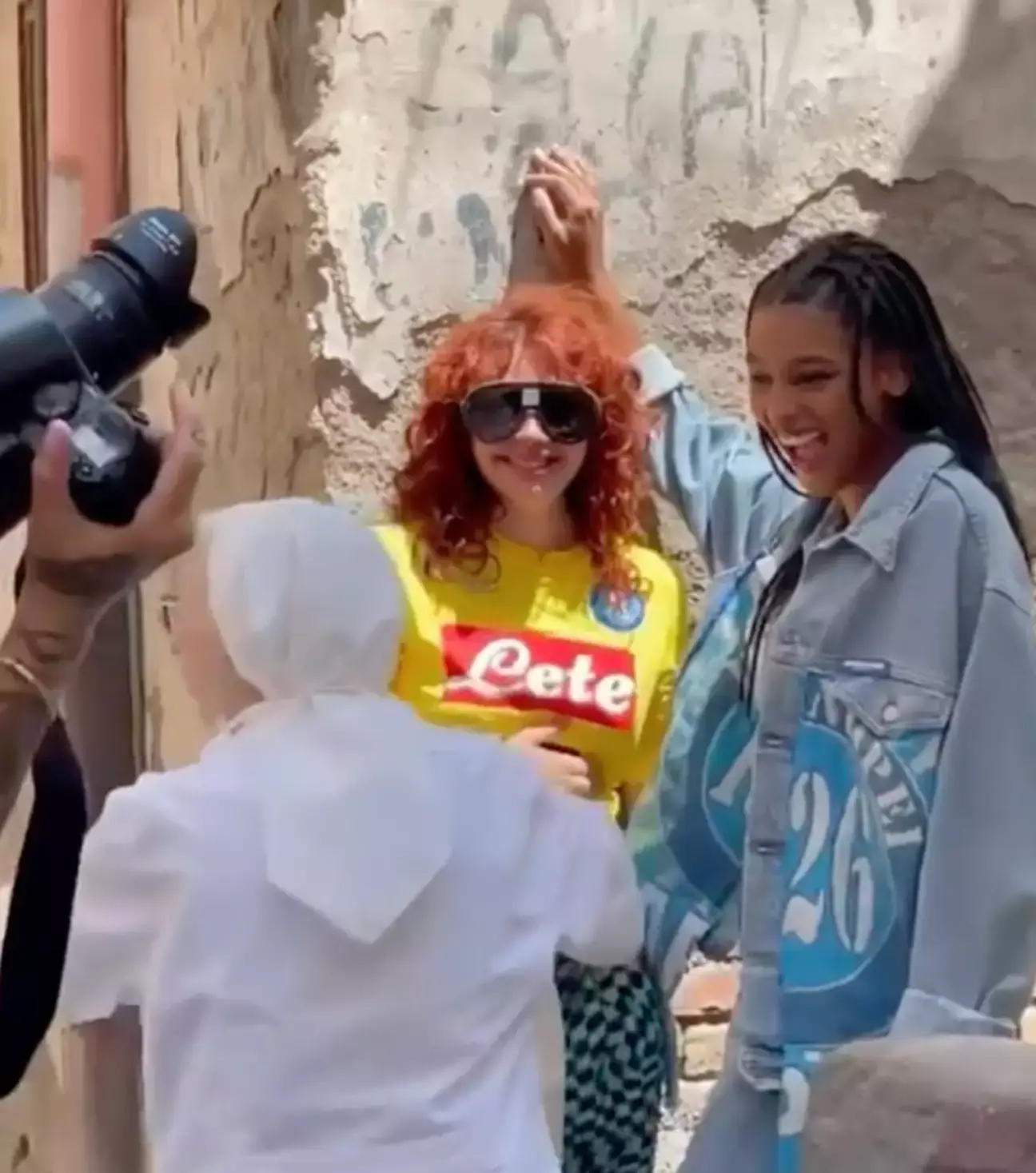 While filming, a nun dressed in all-white habit rushed over and attempted to part the two women.