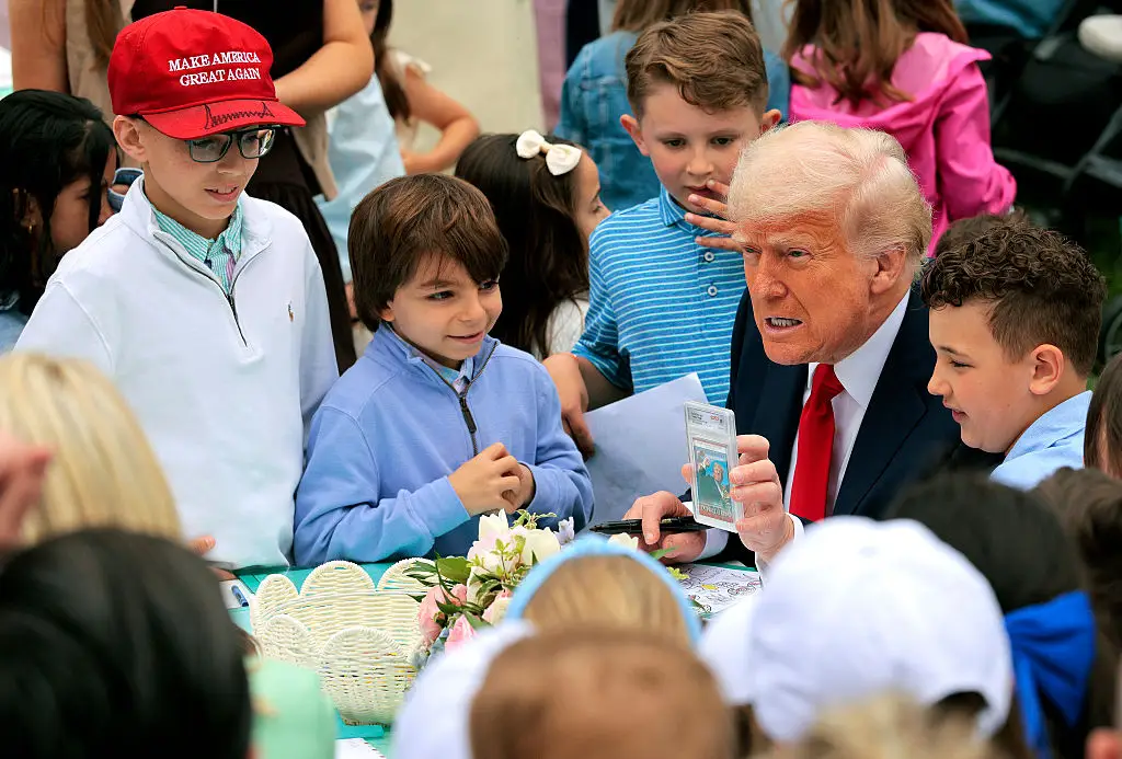 President Donald Trump has been criticized for showing a group of young children a trading card that depicts him with a bloody ear moments after the failed assassination attempt that saw rally attender Corey Comperatore die in the process (Chip Somodevilla/Getty Images)