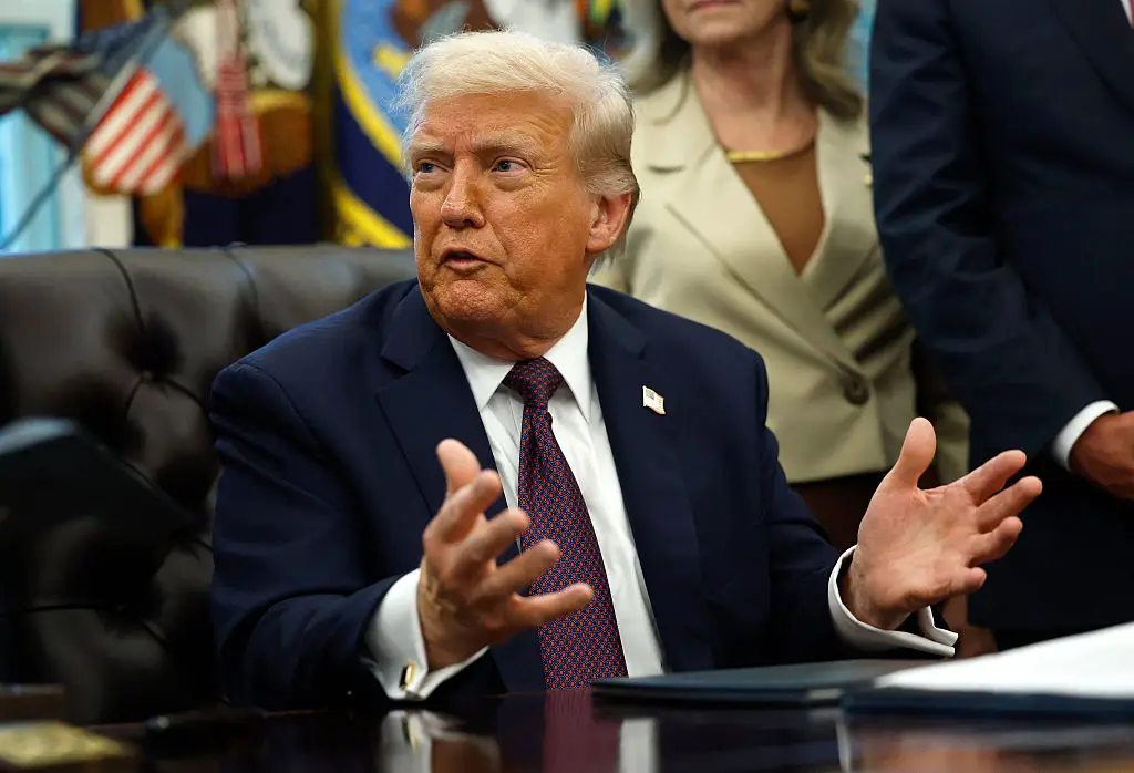 Donald Trump answering reporter questions in the Oval Office (Getty Images)