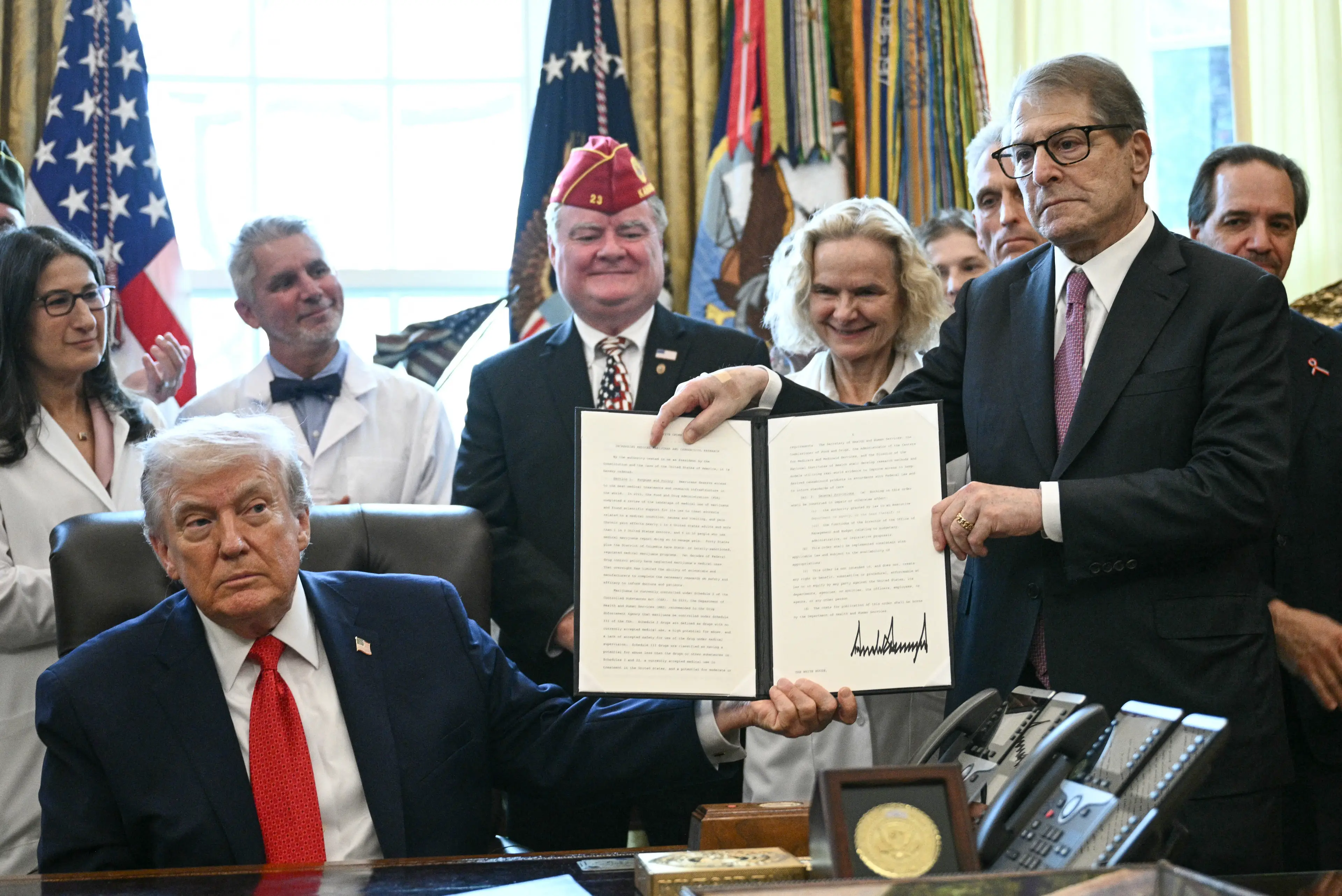 Trump signed the executive order calling for weed to be treated as a less dangerous drug (Brendan SMIALOWSKI / AFP via Getty Images)