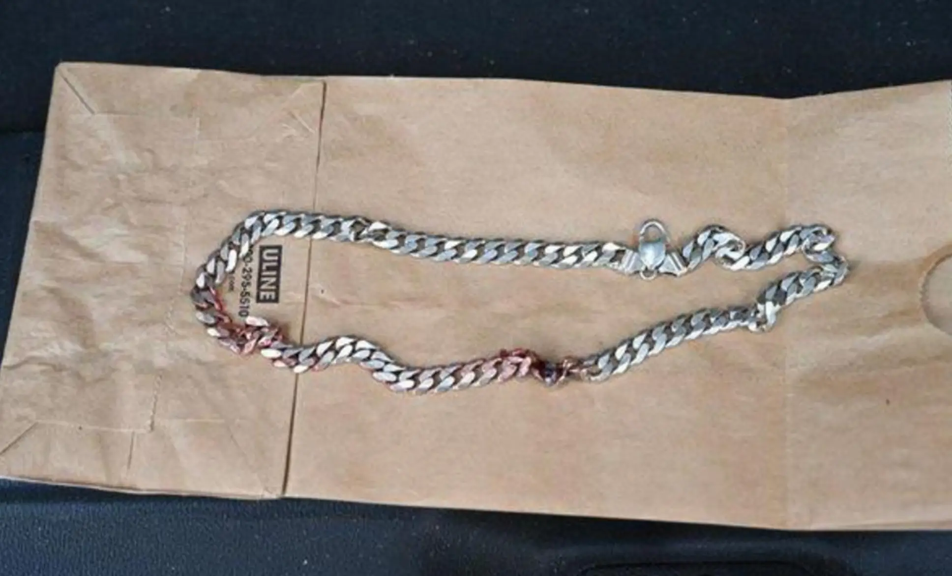 The silver chain necklace is thought to be the reason the man didn't die after the shooting. (Commerce City Police Department)