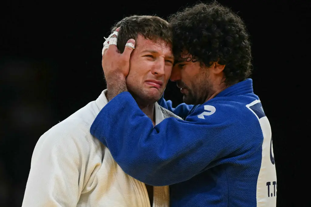 Serbia's Nemanja Majdov and Greece's Theodoros Tselidis (Blue) react after competing in the judo men's -90kg round of 16 bout of the Paris 2024 Olympic Games (LUIS ROBAYO/AFP via Getty Images)