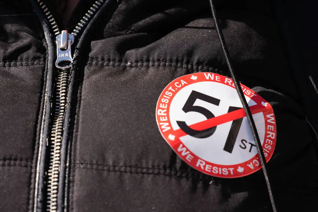 A Canadian wears a sticker protesting Trump's dream of making Canada become the US' 51st state (Mert Alper Dervis/Anadolu via Getty Images)