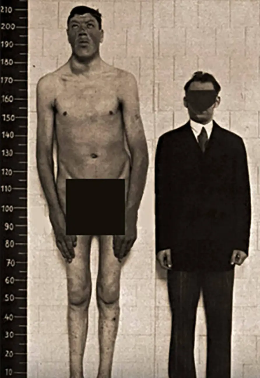 Rainer after his growth spurt next to an average-sized man.