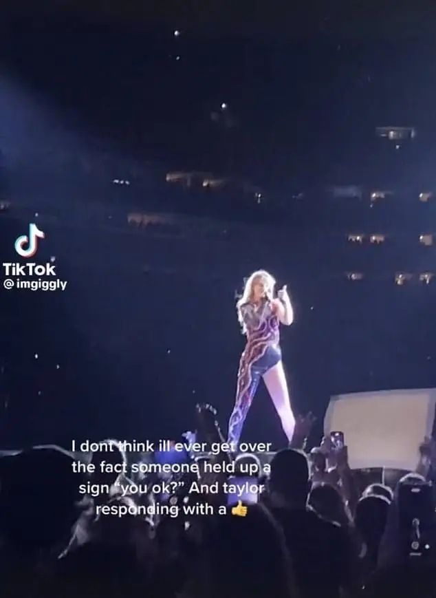 Taylor Swift flashed a thumbs-up to a fan who held up a banner asking if she was OK.