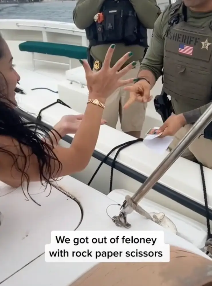 A girl on board the boat played paper and the officer played rock in the last round.