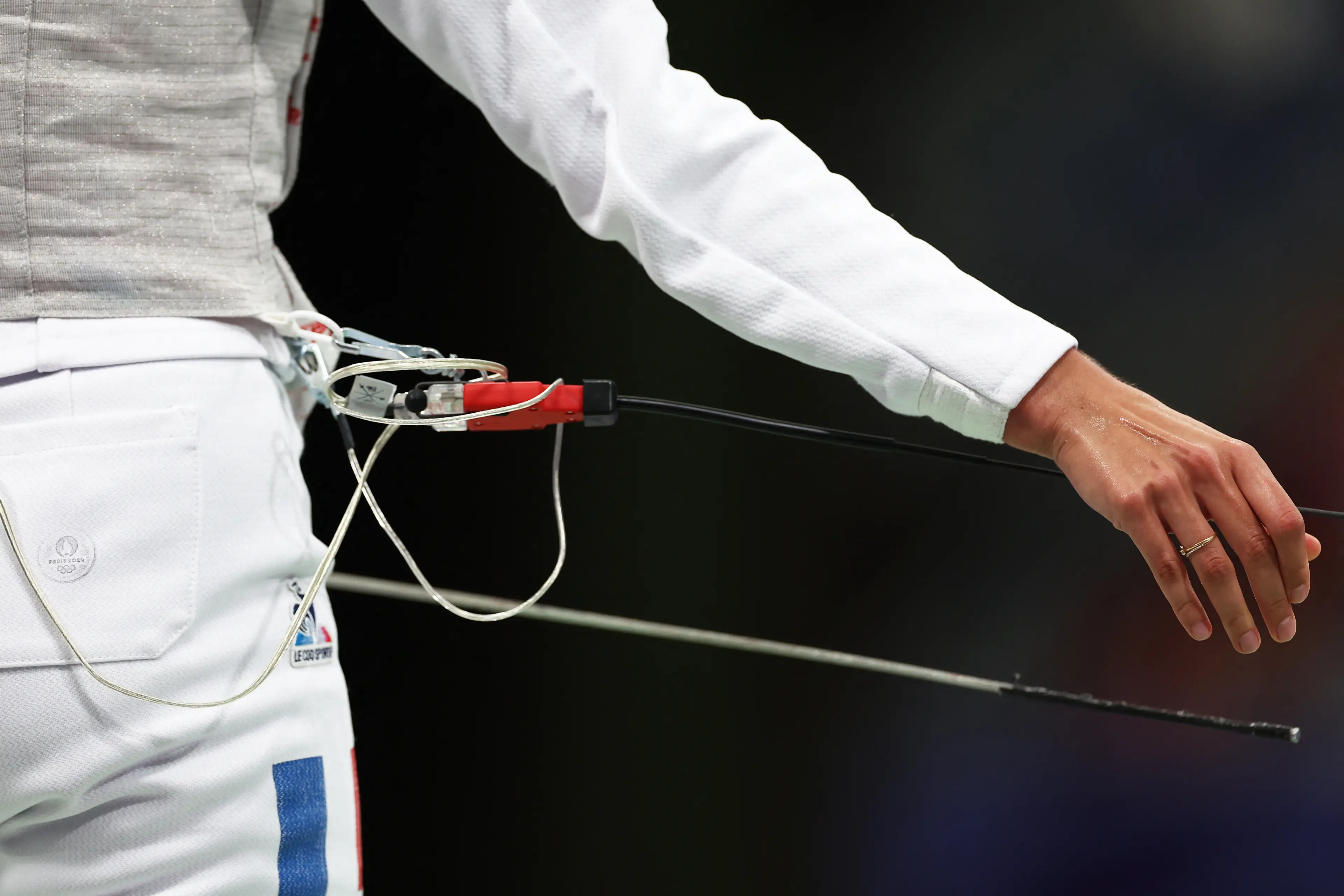 The plug shown here runs up the back of the jacket and down the sleeve of the arm you fence with. (FRANCK FIFE/AFP via Getty Images)
