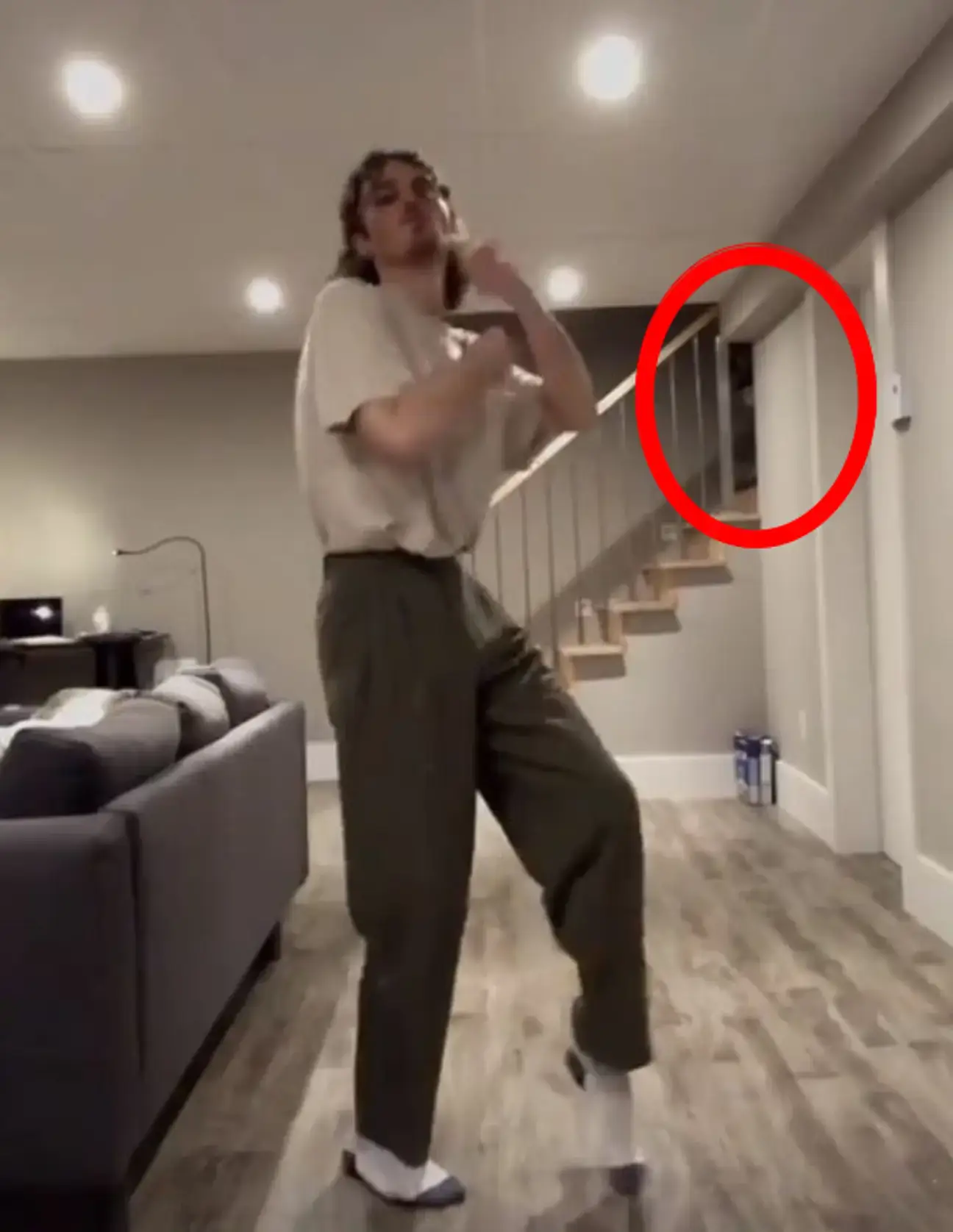 Fans noticed a shadowy figure lurking in the background on his stairs.