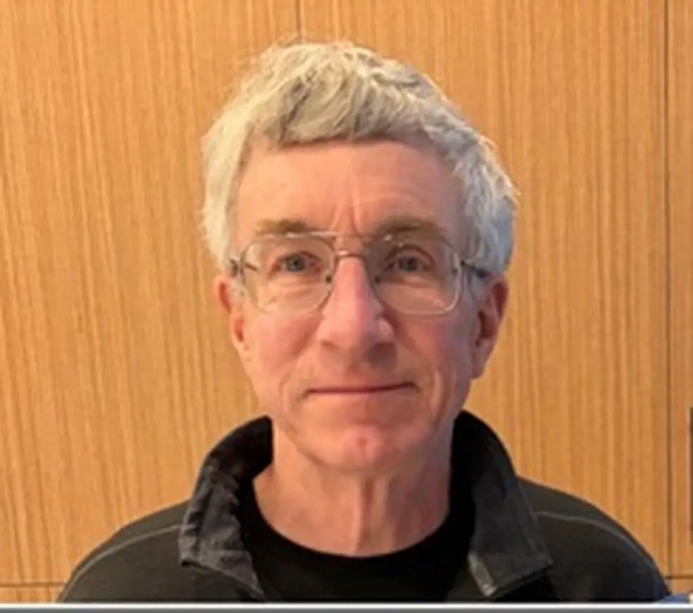 Neil McCasland is described as 5'11 with white hair and blue eyes