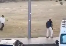 Another civilian is seen running towards the disarmed shooter to throw an object at him (X)