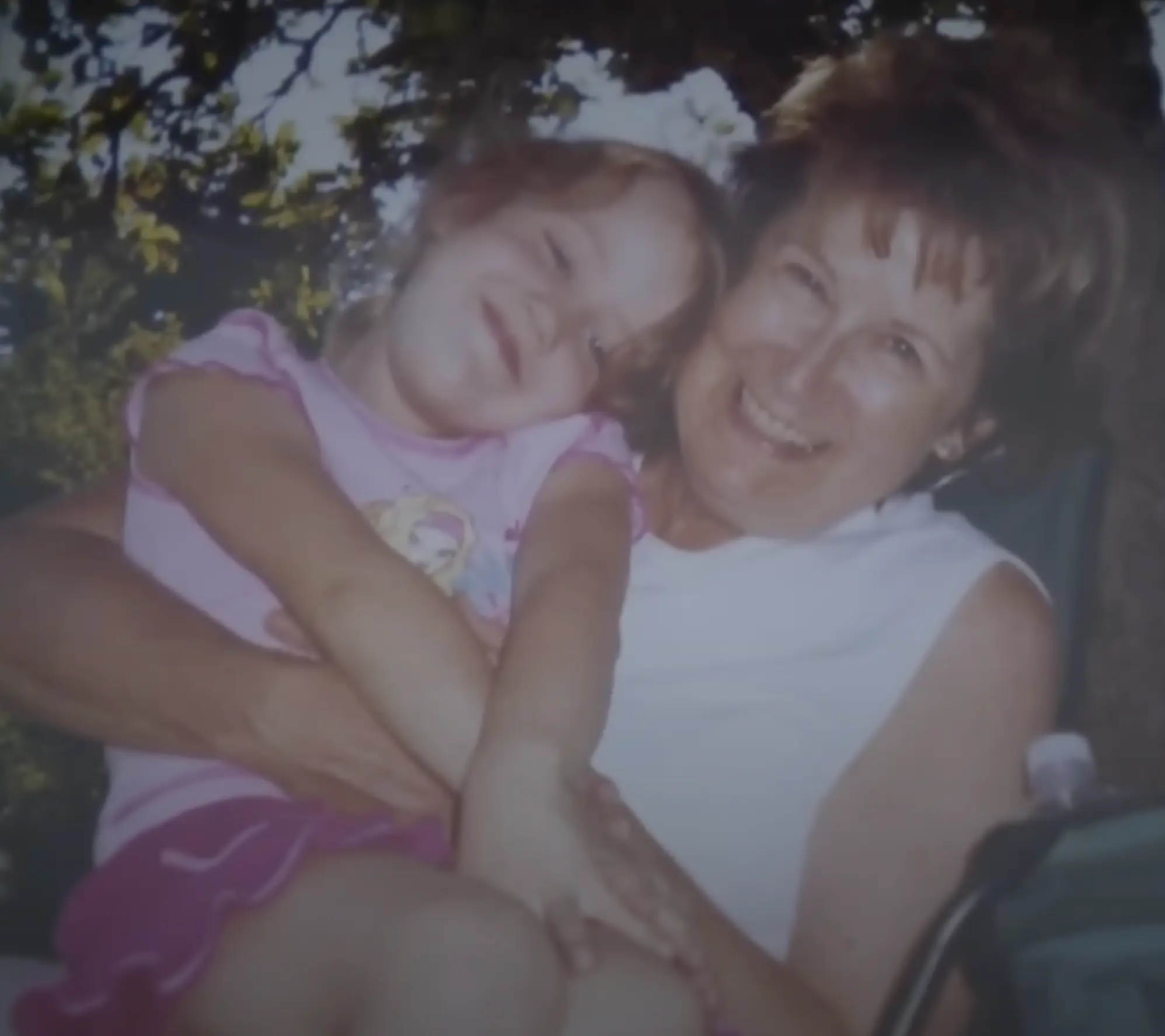 Lane pictured when she could see prior to the auto-immune disorder, decades ago with her daughter (YouTube/Global News)