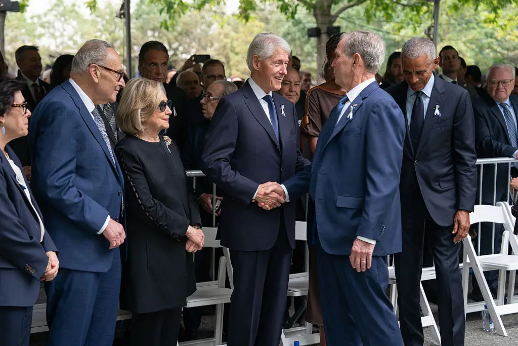 Former US President Bill Clinton, pictured at the ceremony to commemorate the 25th anniversary of the 9/11 attacks, the greets former US President George W. Bush with former US President Barack Obama in the background (Barry Williams - Pool/Getty Images)